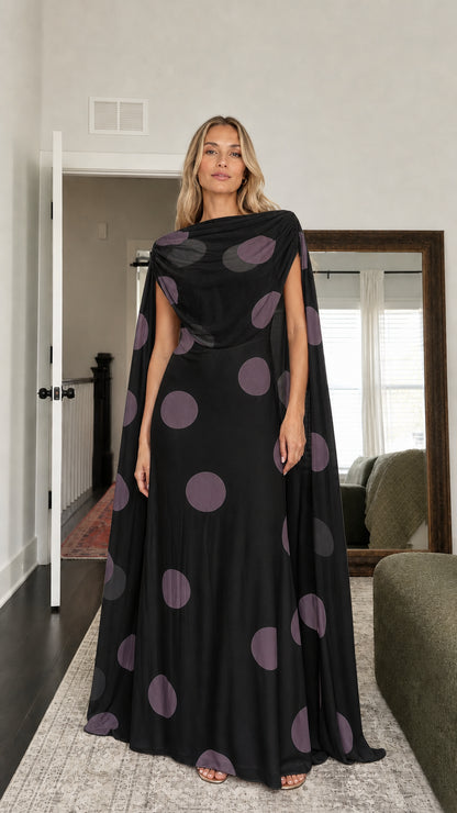 Model wearing black polka dot cape maxi dress
