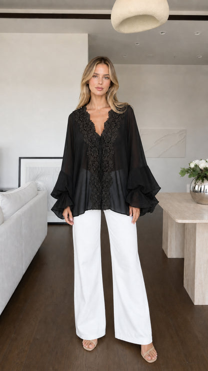 Model wearing black boho lace trim blouse front view