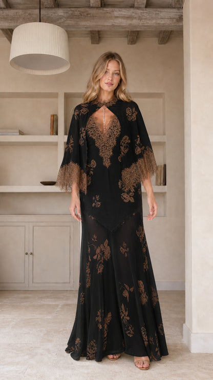 Model wearing black floral maxi dress with cape sleeves