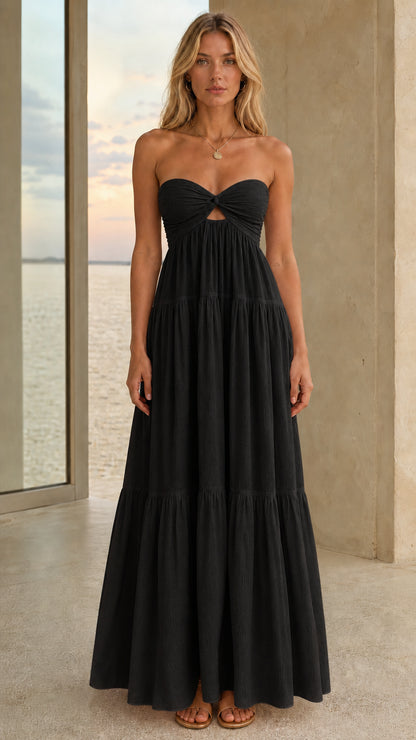 Front view of a black strapless tiered maxi dress