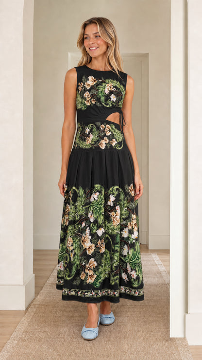 Woman wearing black floral print cutout maxi dress