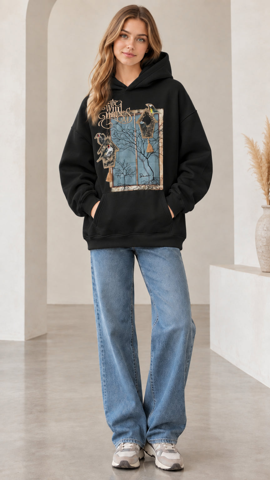 Front view of woman wearing black vintage nature bird graphic hoodie