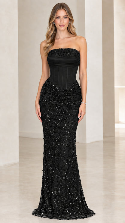 Front view of woman wearing black strapless corset sequin evening gown