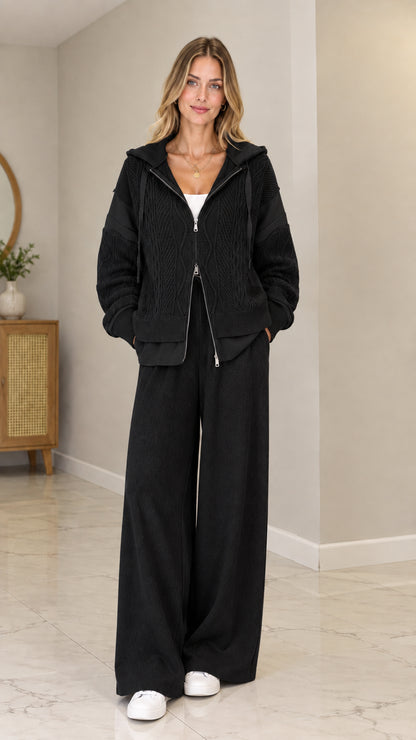 Front view of model wearing Black cable-knit zip-up hooded cardigan set