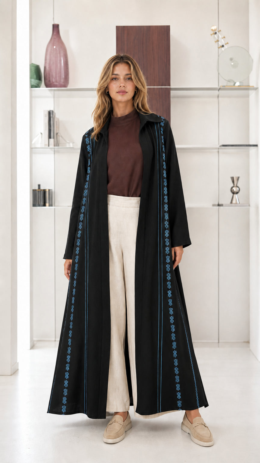 Model wearing Black open front maxi abaya with light blue geometric embroidery
