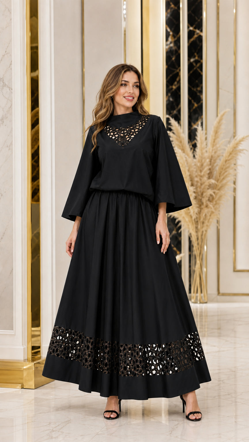 Woman wearing black flared sleeve top and cutout hem maxi skirt set
