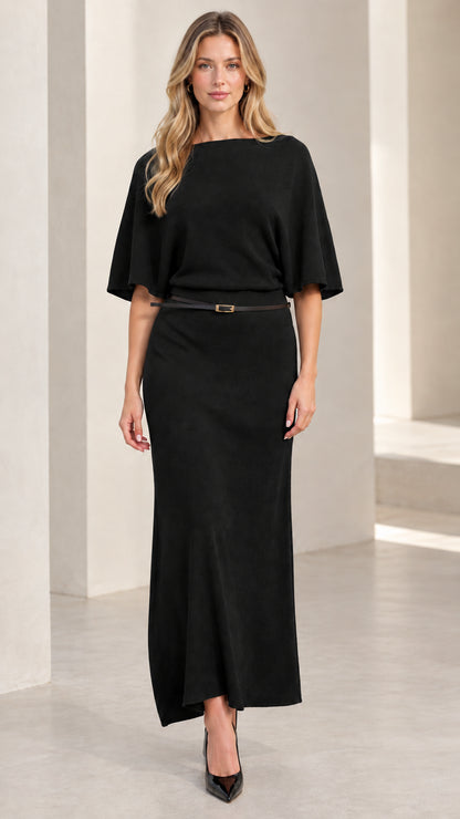 Front view of woman wearing classic black belted knit maxi dress with flutter sleeves