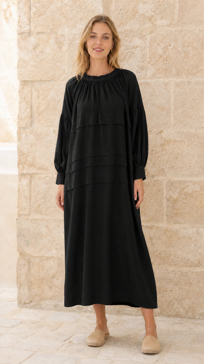 Full front view of model wearing black tiered maxi dress