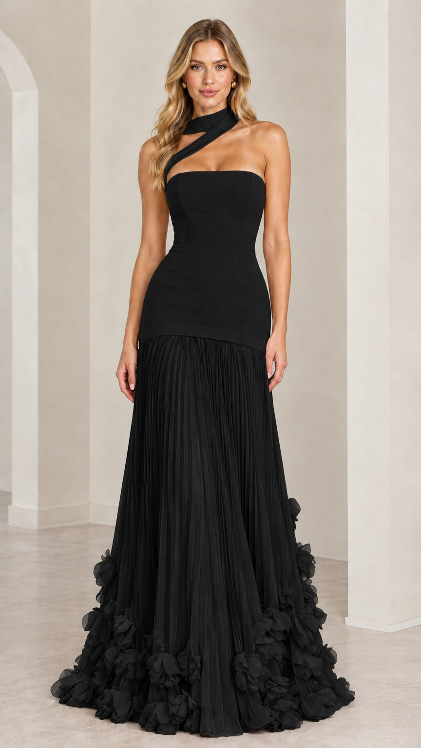Model wearing the classic black asymmetric pleated drop-waist evening gown