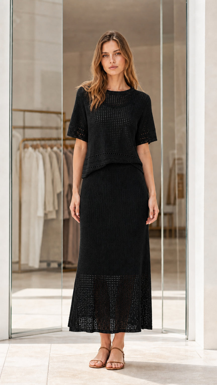 Full front view of black knit two-piece short sleeve top and maxi skirt set