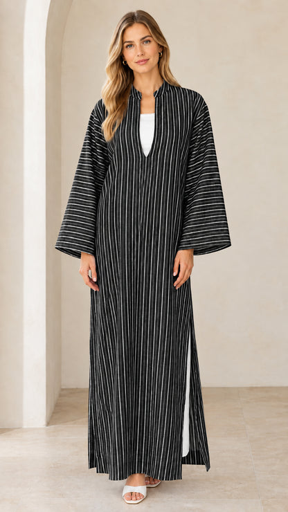 Woman wearing black vertical striped maxi kaftan dress