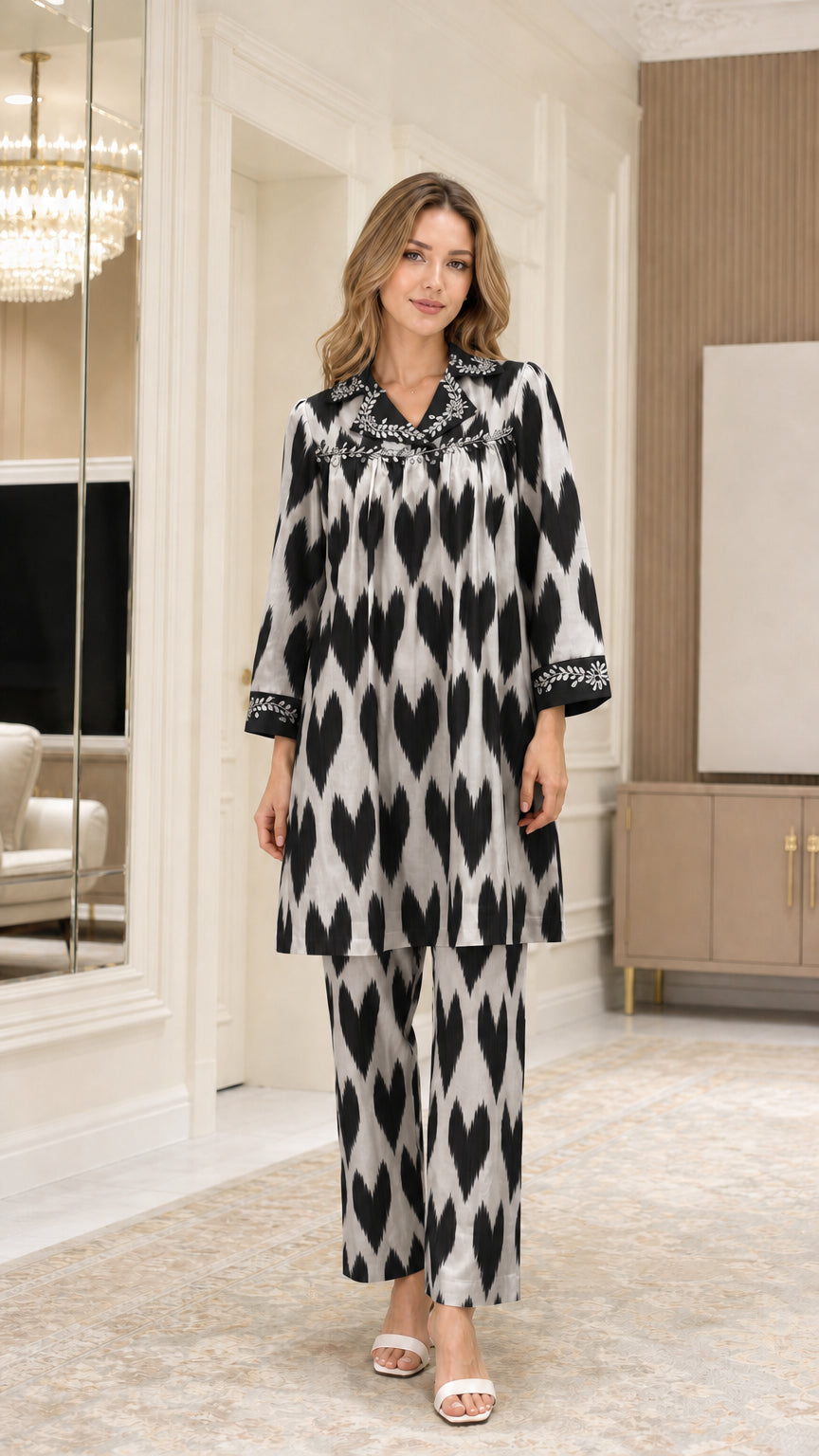 Front view of model wearing Black and white embellished collar ikat print two-piece set