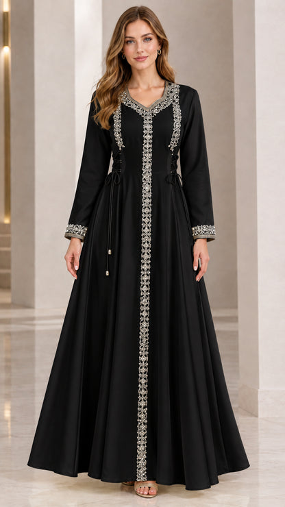 Front view of woman wearing black embellished long sleeve maxi dress