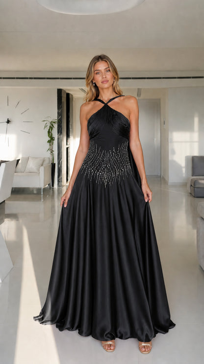 Model wearing black halter neck satin maxi dress