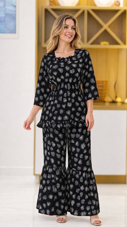 Black floral print 2-piece smocked top and flared pant set on model