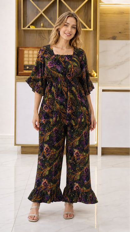 Front view of woman wearing Black multicolor floral smocked top and wide-leg pant set
