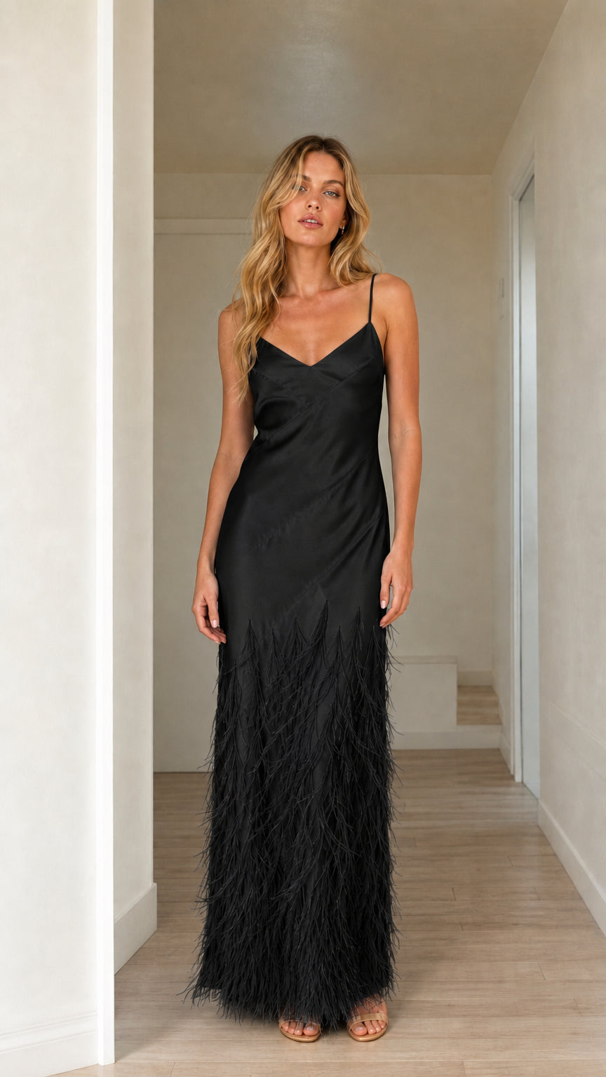 Woman wearing black satin feather trim maxi slip dress