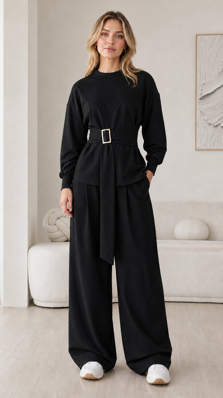 Model wearing black belted long sleeve top and wide leg pants matching set