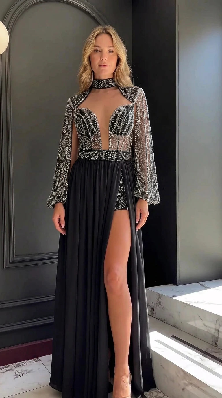 Model wearing black beaded long sleeve evening romper gown with chiffon overskirt