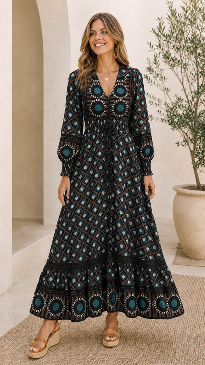 Full front view of model wearing Black geometric print smocked tiered maxi dress