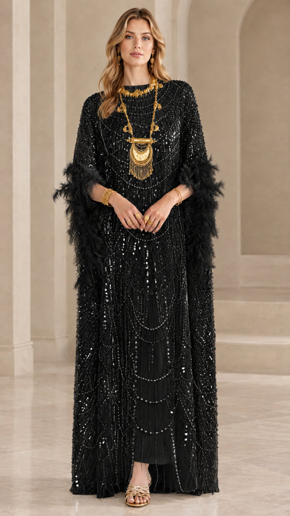 Model wearing black sequin kaftan maxi dress with black feather trim