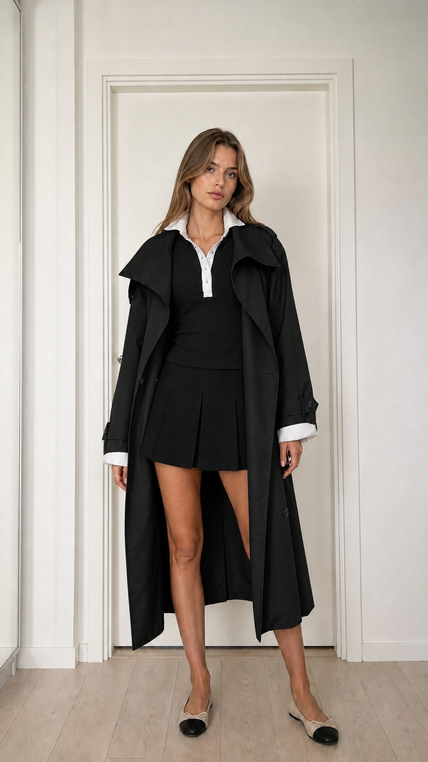 Front full-length view of model wearing black double-breasted long trench coat