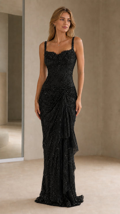 Front view of model wearing black beaded evening gown