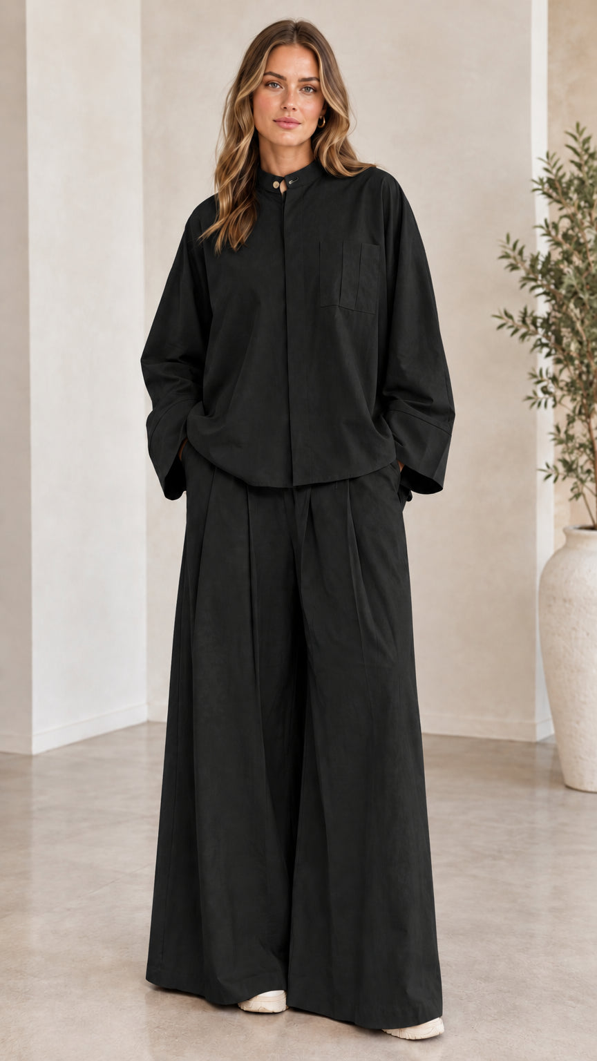 Front view of woman wearing the matching two-piece wide-leg set in black