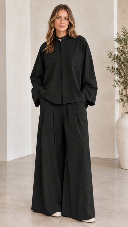 Front view of woman wearing the matching two-piece wide-leg set in black