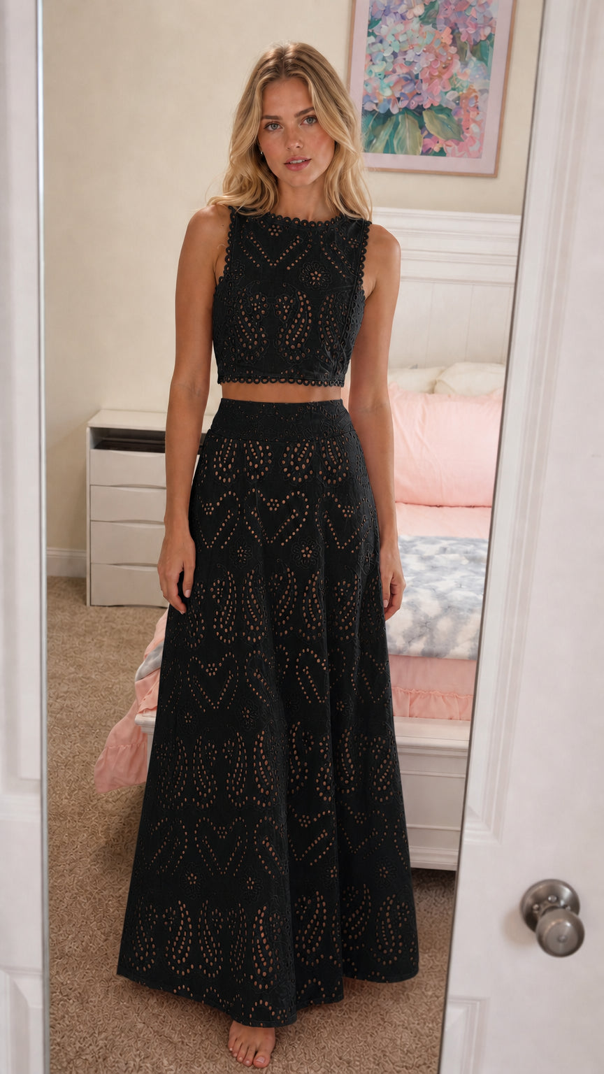 Front view of model wearing black eyelet two-piece set