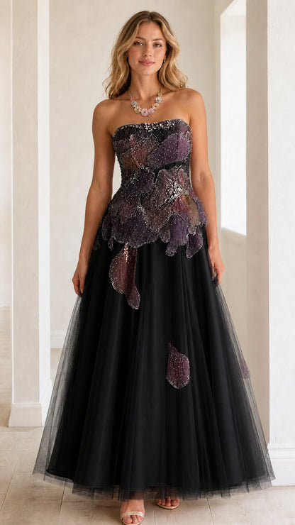 Front view of strapless black tulle evening ball gown with beaded petal bodice