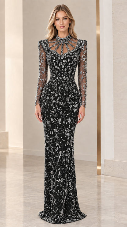Front view of black beaded long sleeve evening gown with illusion neck