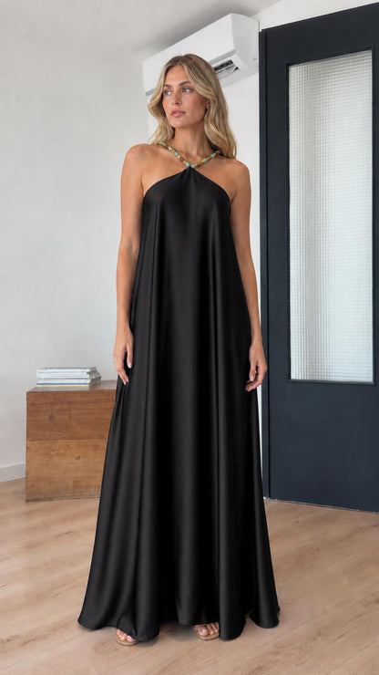 Model wearing black satin halter maxi dress