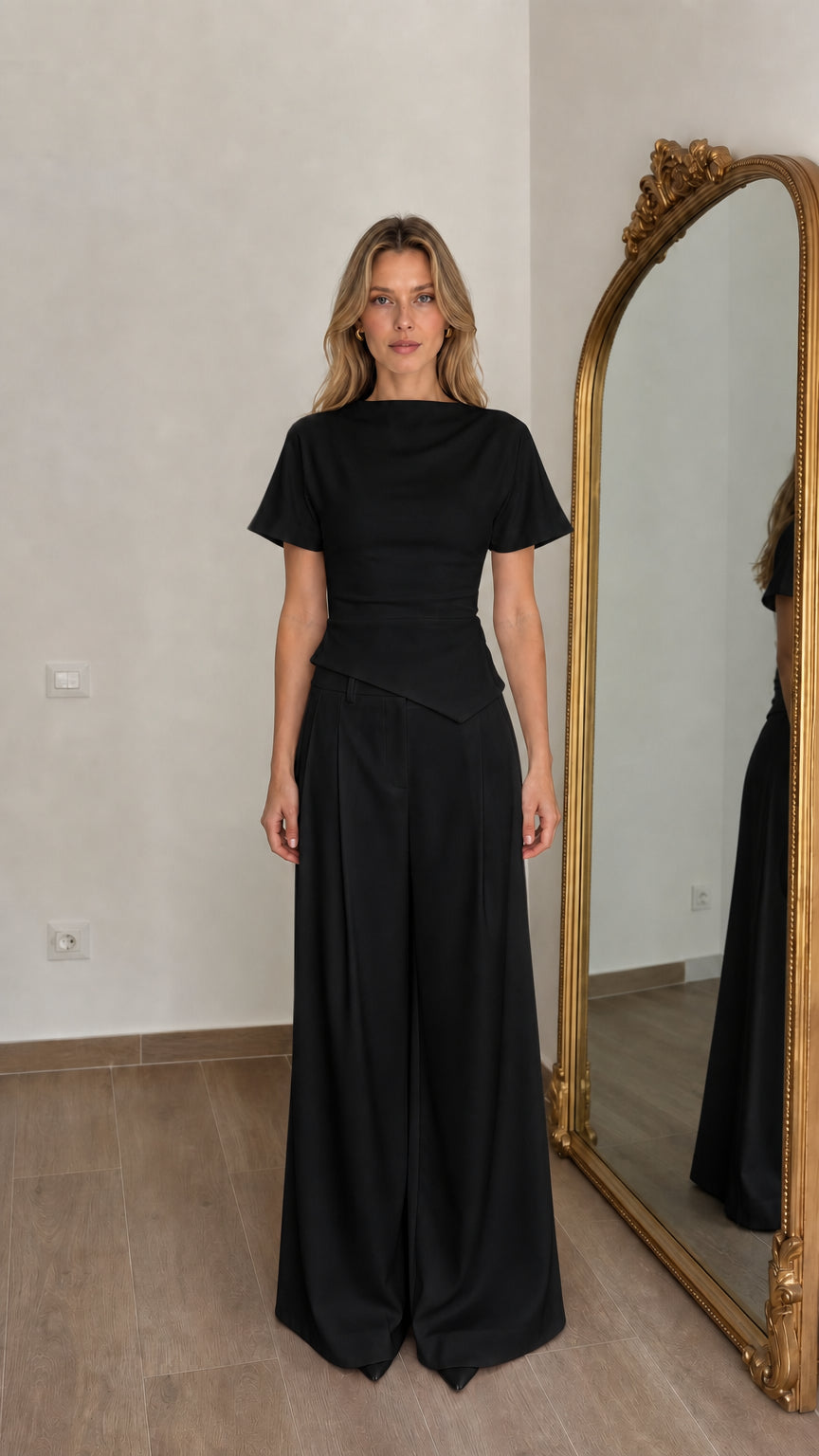 Front view of woman wearing black matching top and wide-leg pants