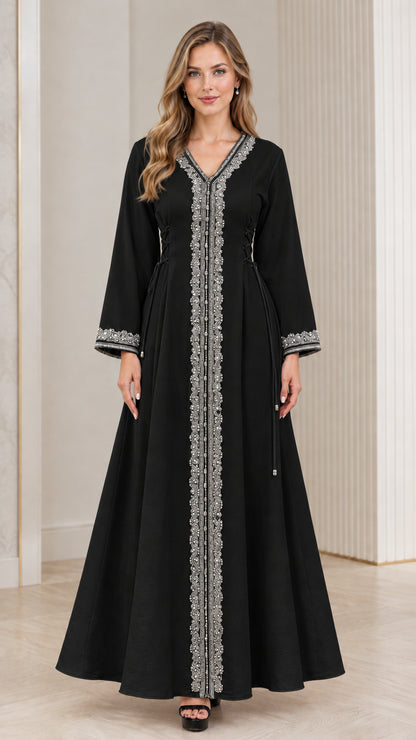 Full-length view of woman wearing black embroidered kaftan dress with waist ties