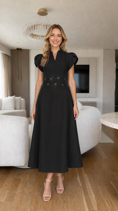 Front view of black tulip sleeve A-line midi dress with beaded waist