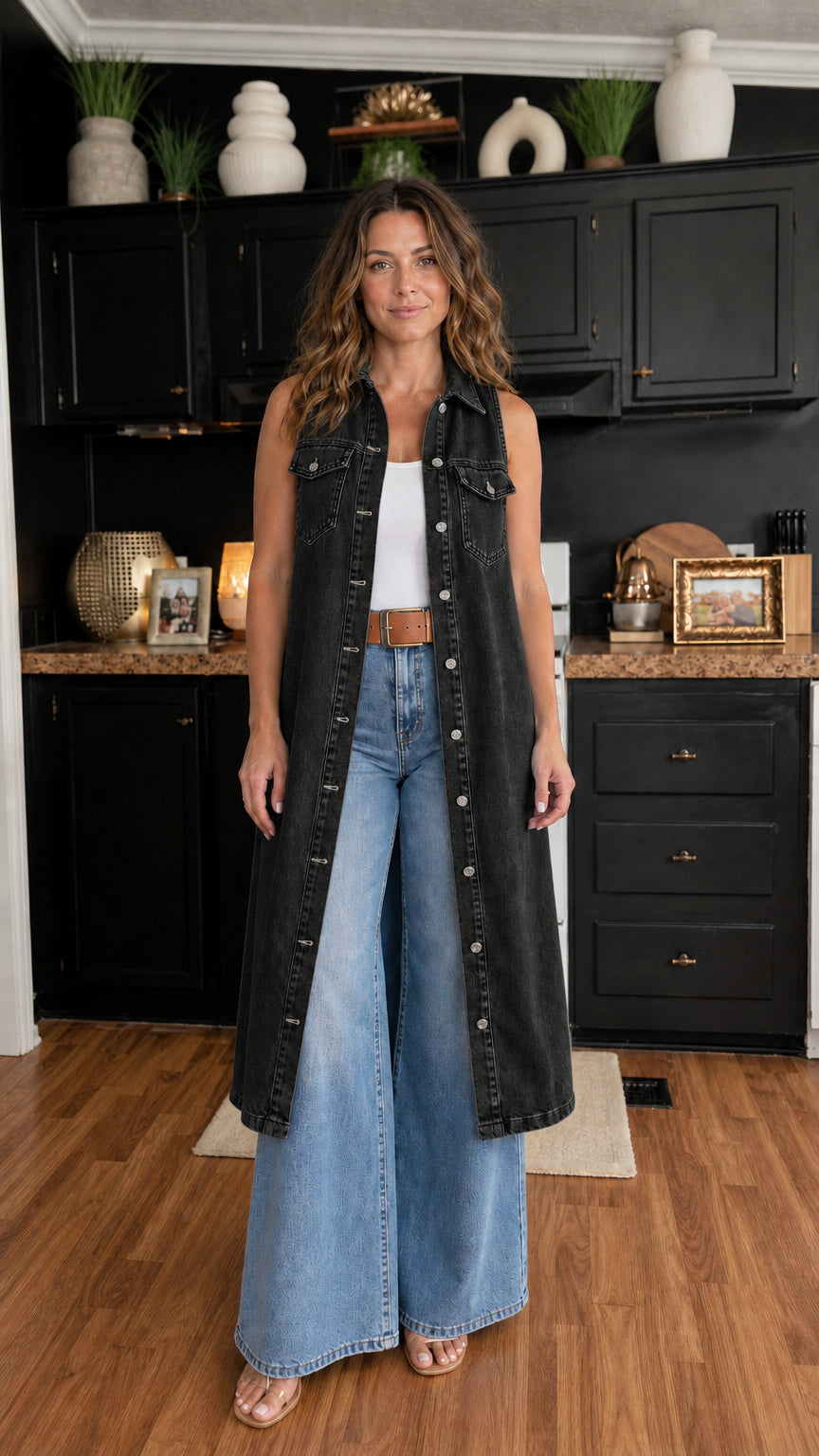 Woman wearing black longline denim vest over white top