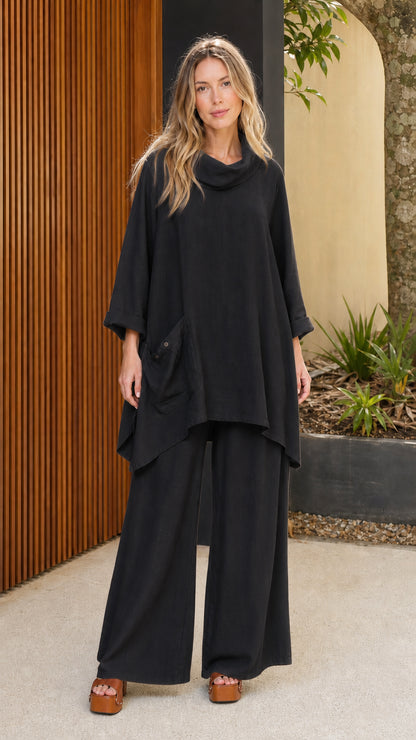 Model wearing black cowl neck tunic and wide leg pants set