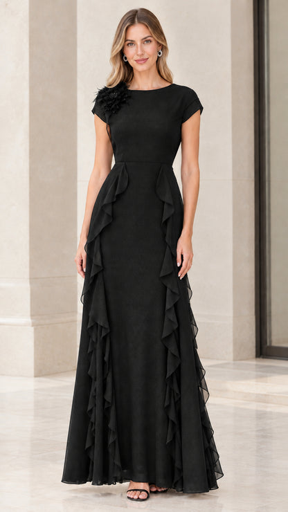 Front view of woman wearing elegant black cap sleeve ruffle evening gown