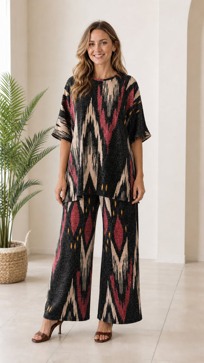 Woman wearing black and cream ikat print two piece tunic and wide leg pant set