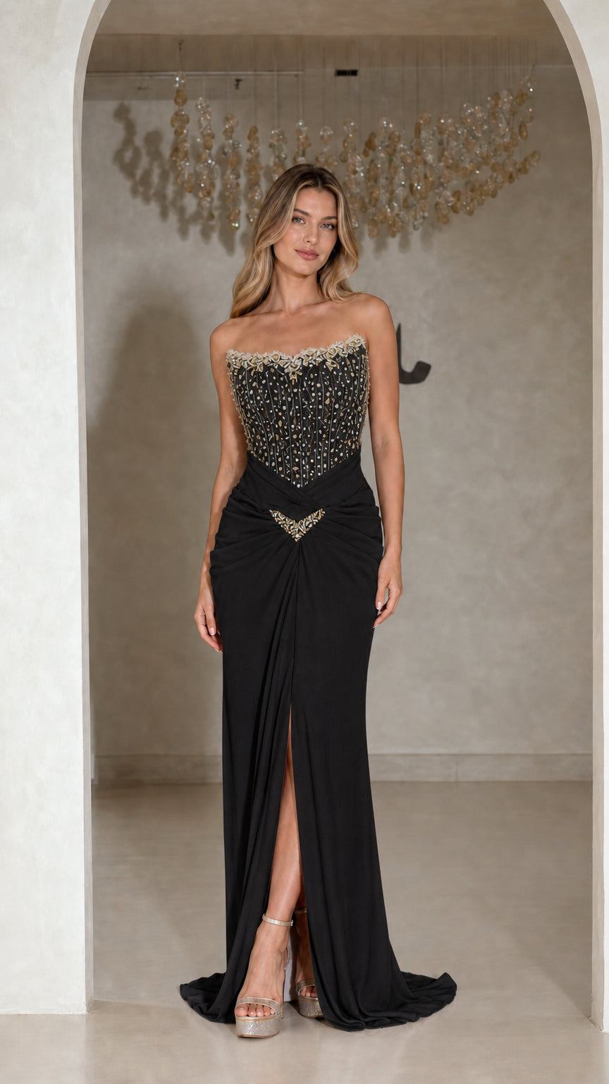 Front view of strapless black beaded corset evening gown with front slit