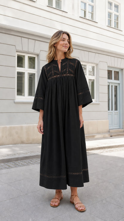 Woman wearing Black embroidered bohemian caftan maxi dress