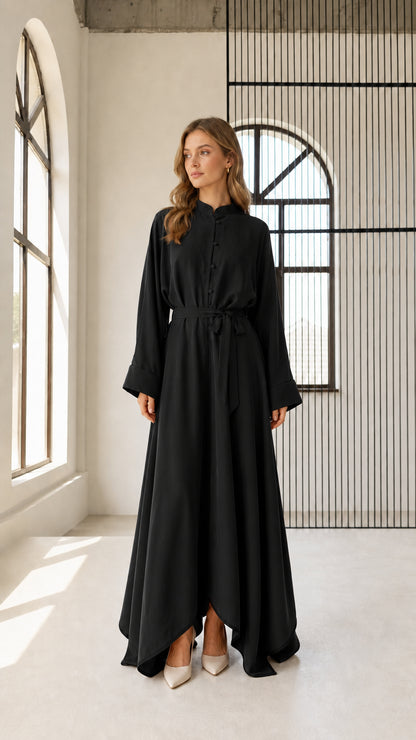 Front view of woman wearing black long sleeve belted maxi dress