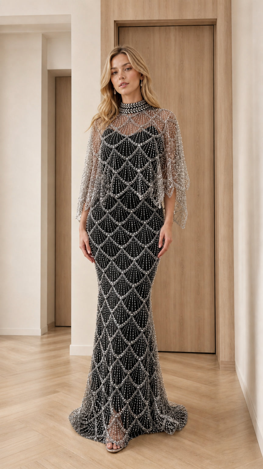 Front view of black pearl-embellished high neck capelet evening gown