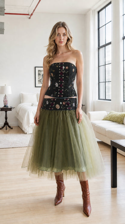 Model wearing black corset top paired with sage green tulle skirt