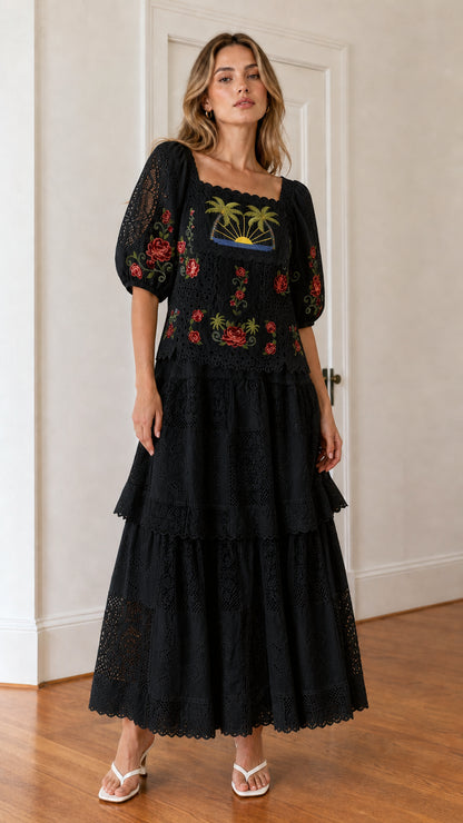 Front view of woman wearing black embroidered maxi dress