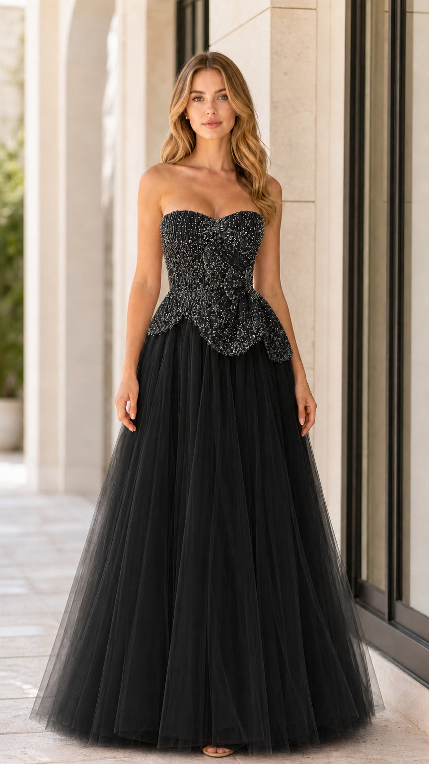 Front full-length view of black strapless beaded tulle ball gown