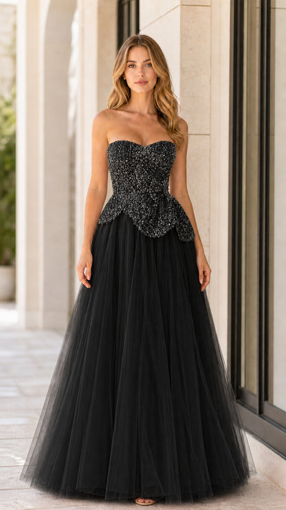 Front full-length view of black strapless beaded tulle ball gown