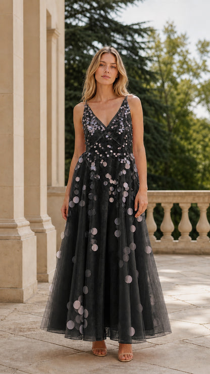 Full length view of woman in black sequin tulle maxi dress
