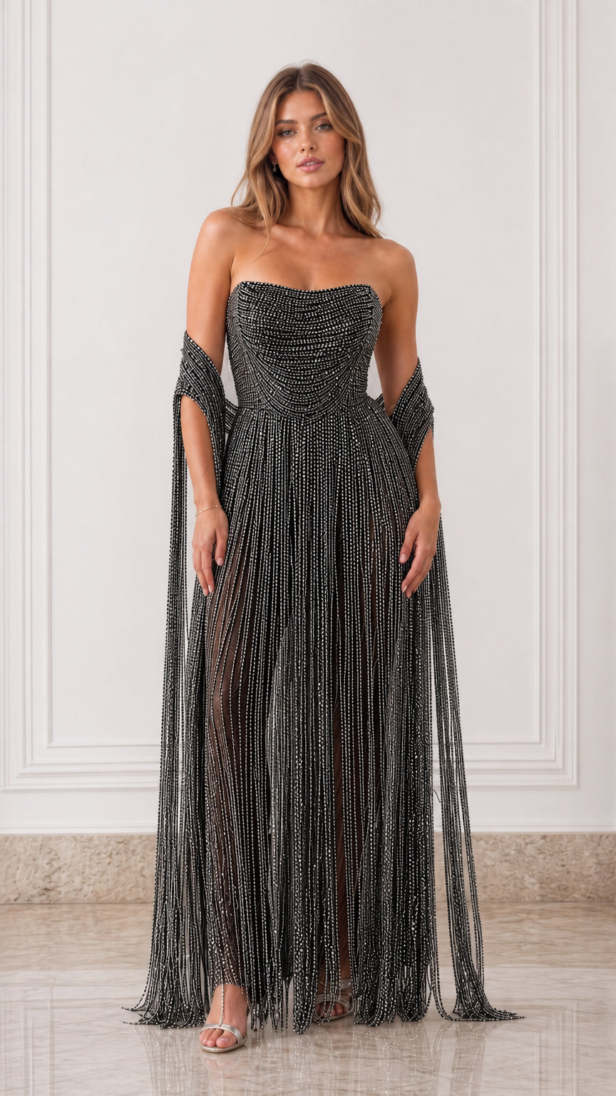 Full-length front view of black strapless beaded fringe evening gown